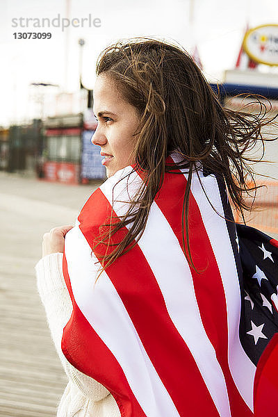 Seitenansicht einer mit amerikanischer Flagge bedeckten Frau