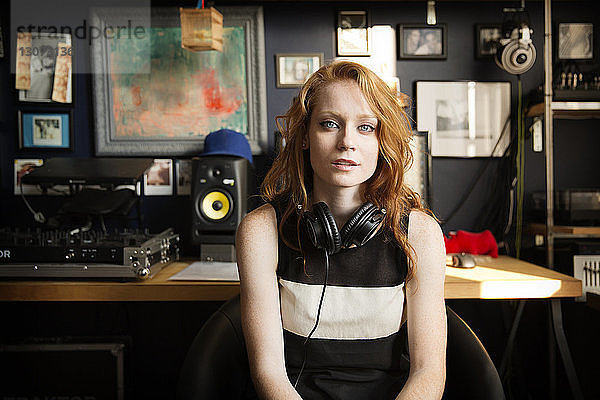Porträt eines weiblichen DJs  der im Tonstudio sitzt