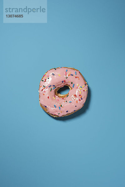 Draufsicht auf Doughnut auf blauem Hintergrund