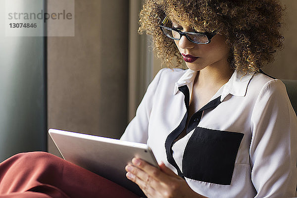 Geschäftsfrau benutzt Tablet-Computer in der Hotellobby