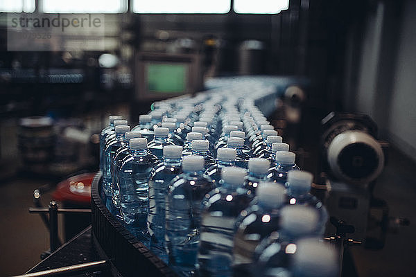 Nahaufnahme von Wasserflaschen auf einem Förderband in der Fabrik