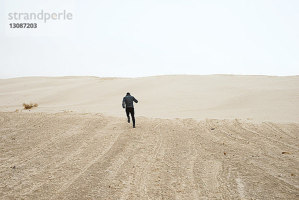 Mann rennt durch die Wüste