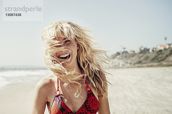 Porträt einer fröhlichen Frau am Strand