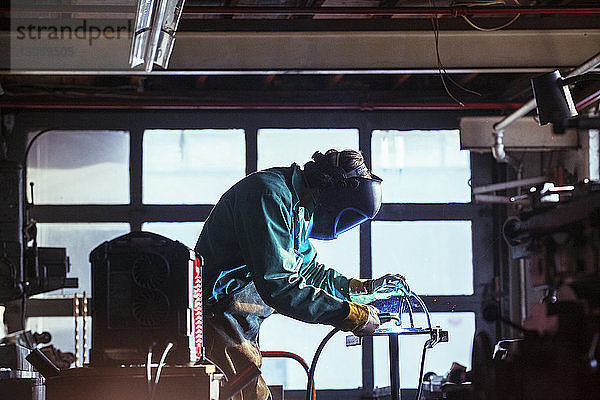 Arbeiter mit Schweißbrenner in der Werkstatt