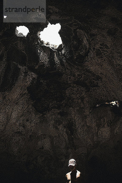 Sonnenlicht fällt auf in Höhle stehenden Mann