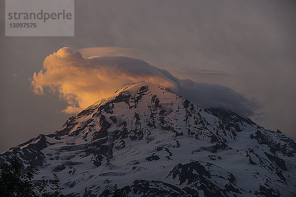 Szenische Ansicht eines schneebedeckten Berges gegen den Himmel bei Sonnenuntergang