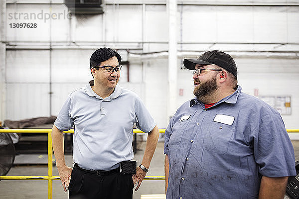 Arbeiter diskutieren im Stehen in einer Fabrik der Stahlindustrie