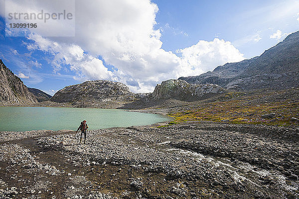 Wanderer in voller Länge am Seeufer des Garibaldi-Provinzparks gegen den Himmel stehend