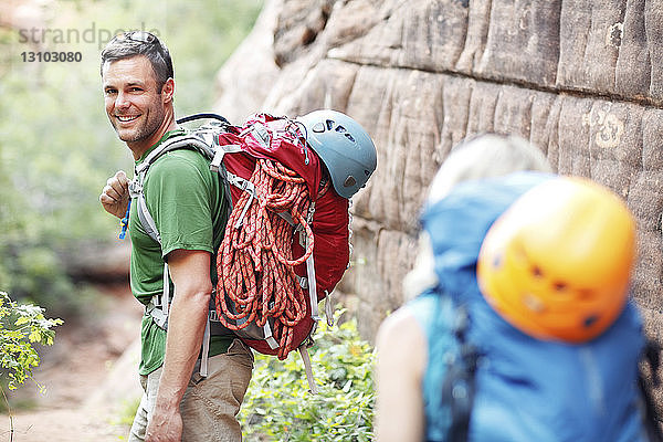 Glückliches Paar mit Rucksäcken beim Wandern