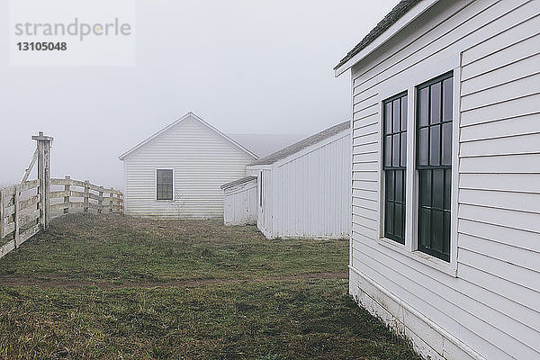 Nebengebäude und Scheune auf einem Bauernhof in dichtem Nebel in Kalifornien  USA.
