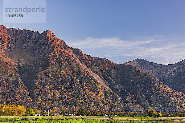 Pyrah's U-Pick Farm unterhalb von Pioneer Peak  beleuchtet von der untergehenden Sonne  Süd-Zentral-Alaska; Palmer  Alaska  Vereinigte Staaten von Amerika