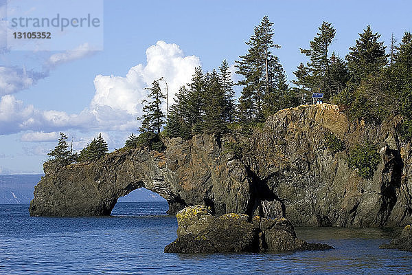 Scenic View Of A Natural Arch Through Cliffs At Halibut Cove  Alaska During Summer