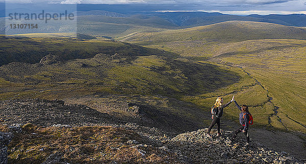 Zwei Frauen erkunden die Berge und die Wildnis des Yukon. Sie fühlen sich lebendig und dynamisch in der wunderschönen Landschaft um Haines Junction; Yukon  Kanada