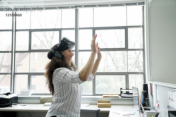 Geschäftsfrau trägt Virtual-Reality-Simulator im Büro