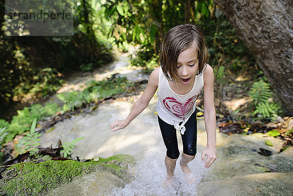 Hochwinkelaufnahme eines Mädchens  das an den Bua-Thang-Wasserfällen steht