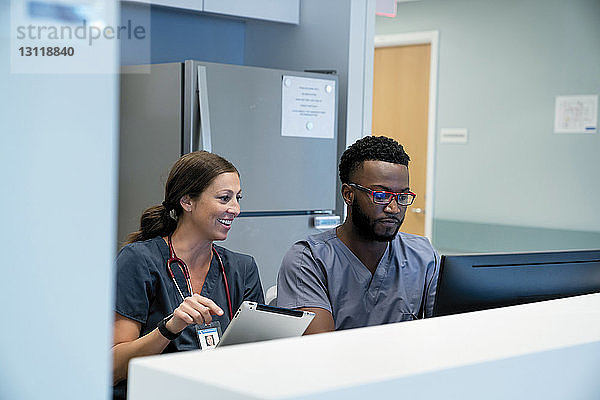 Ärzte  die bei der Arbeit im Krankenhaus auf den Desktop-Computer schauen