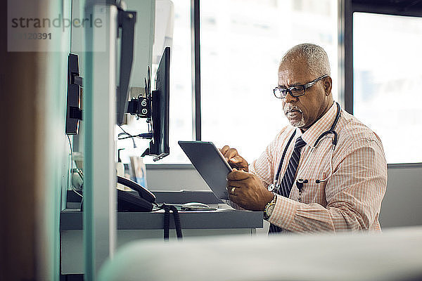 Arzt benutzt Tablet-Computer im Krankenhaus