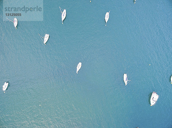 Draufsicht auf Segelboote  die auf blauer See vor Anker liegen