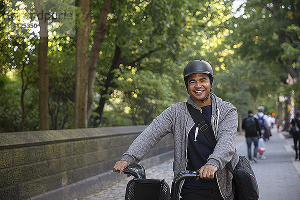 Porträt eines selbstbewussten Mannes mit Fahrrad auf einem Fußweg in der Stadt