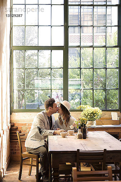 Küssende Paare am Tisch im Restaurant