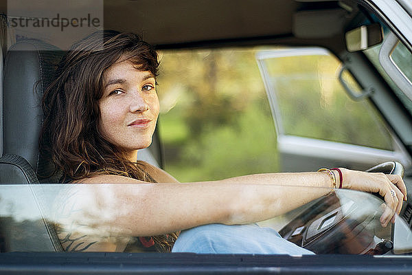 Porträt einer selbstbewussten Frau  die im Lieferwagen sitzt