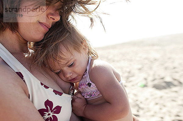 Nahaufnahme einer Mutter mit Mädchen  die an einem sonnigen Tag am Strand steht