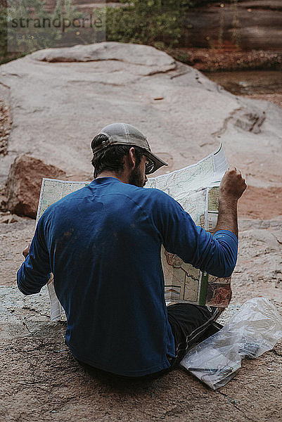 Rückansicht eines Kartenlesers beim Sitzen im Grand Canyon National Park