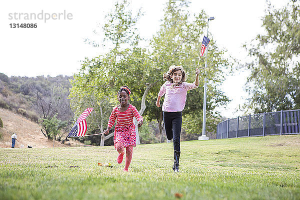 Kinder spielen mit amerikanischer Flagge im Park