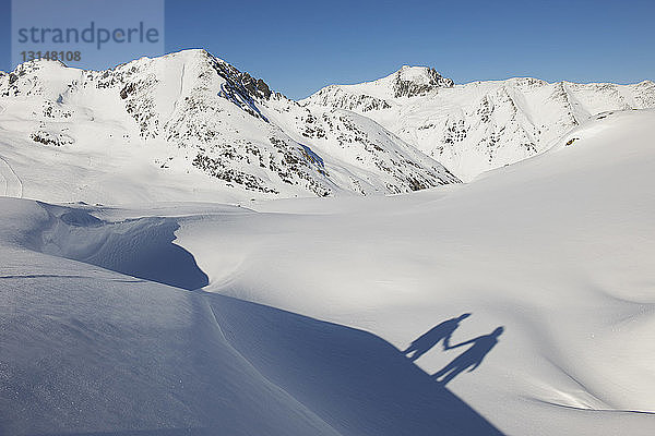 Schatten eines händchenhaltenden Paares im Schnee  Kuhtai  Österreich