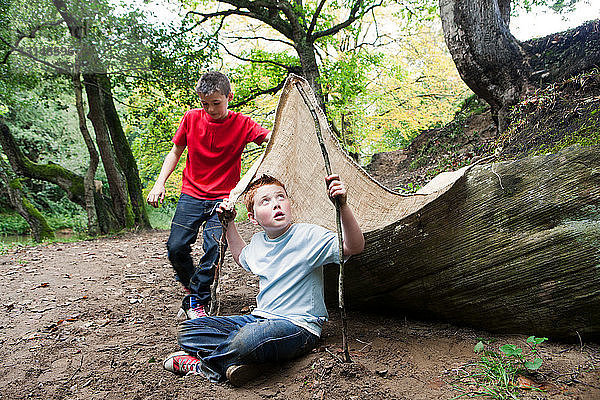 Jungen mit Höhle im Wald