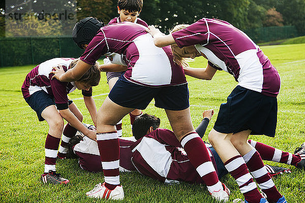 Aggressiv spielende Rugby-Mannschaft von Schulkindern