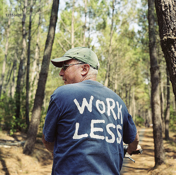 Seniorin im Wald in Work Less-T-Shirt