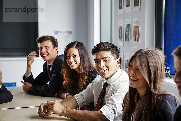 Teenager-Schüler sitzen im Klassenzimmer an den Tischen