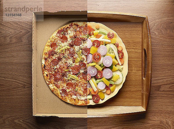 Halb Pizza  halb Gemüse auf einem Teller  Draufsicht