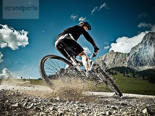 Männlicher Mountainbiker beim Bergabfahren