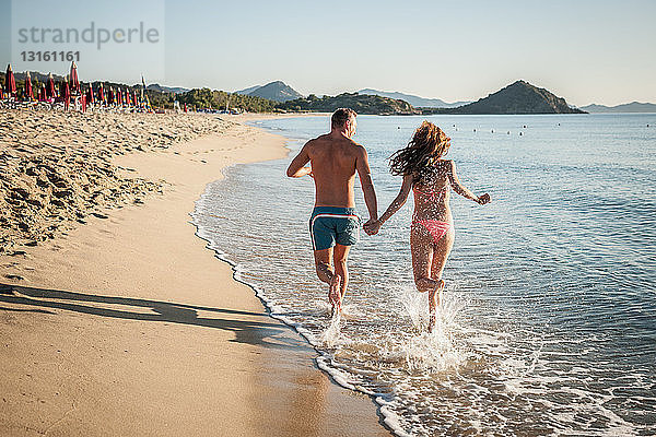 Junges Paar läuft im Meer  Castiadas  Sardinien  Italien