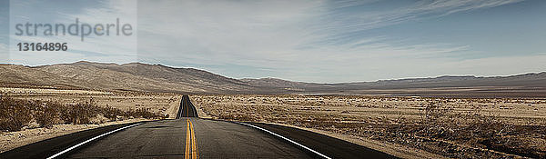 Panoramablick auf einen leeren Highway in einer Wüstenlandschaft  Trona  Kalifornien  USA