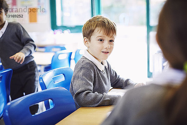 Jungen und Mädchen am Schreibtisch in der Grundschule