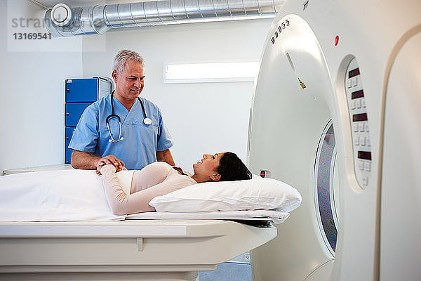 Arzt beruhigt Patient vor CT-Untersuchung