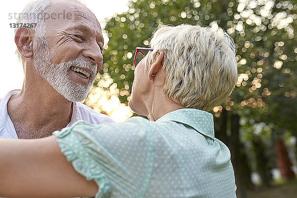Glückliches älteres Paar umarmt sich im Freien