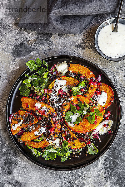 Herbstlicher Salat mit gebratenem Kürbis  Linsen  Radicchio  Granatapfelkernen  Blattsalat und Petersilie mit Dressing