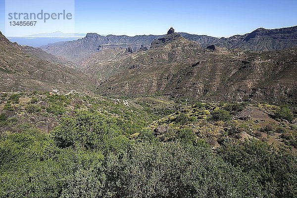 Blick von der Straße GC60 im Barranco del Chorrillo bei Tejeda  hinter der Insel Teneriffa mit dem Vulkan Teide  dem Berg Altavista und dem Kultfelsen Roque Bentayga  Gran Canaria  Kanarische Inseln  Spanien  Europa