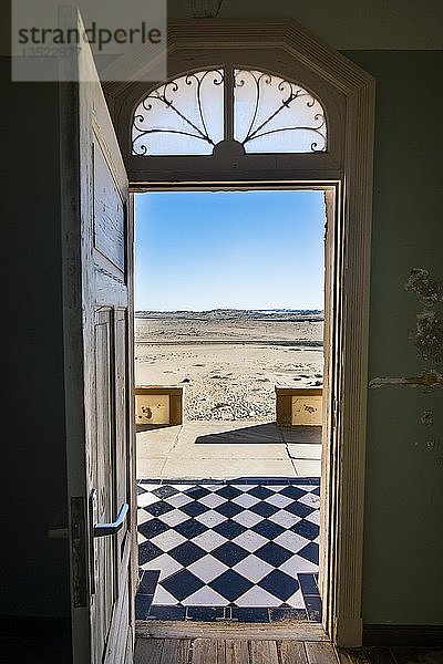 Blick durch eine Tür in die Wüste  alte Bergbaustadt Kolmanskop oder Coleman's Hill  bei Lüderitz  Namibia  Afrika