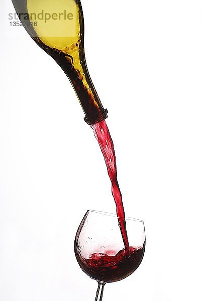 Rotwein wird aus Weinflasche in Weinglas gegossen  Ausschnitt  Deutschland  Europa