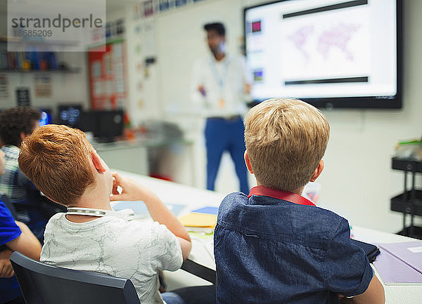 Jungen der Junior High School beobachten Lehrer während des Unterrichts im Klassenzimmer