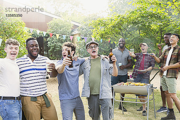 Fröhliche  ausgelassene männliche Freunde trinken Bier und singen beim Grillen im Hinterhof