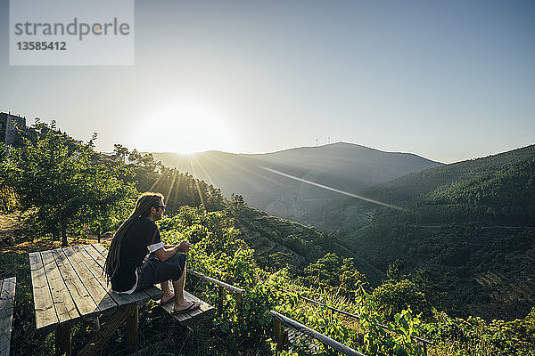 Mann genießt sonnigen  idyllischen Landschaftsblick  Chas de Egua  Portugal