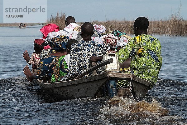 Afrikaner transportieren Ausrüstung auf einem Boot  Nokoue-See  Ganvie.