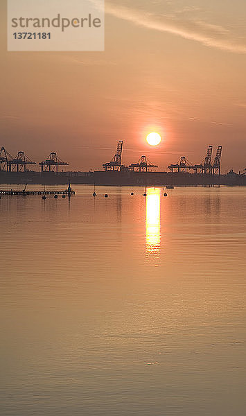 Sonnenaufgang über den Kränen des Hafens von Felixstowe  Suffolk  England  von Harwich aus gesehen