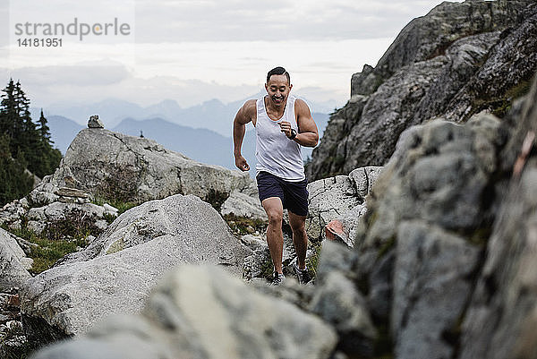 Männlicher Wanderer läuft über Felsen  Dog Mountain  BC  Kanada
